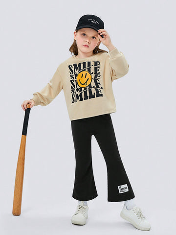 Young Girl Cartoon Face & Letter Graphic Drop Shoulder Hoodie & Flare Leg Pants